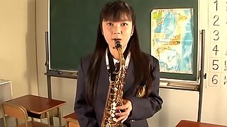 Playful student chick blows the pipe in the college room