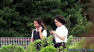 Teens in uniform peeing